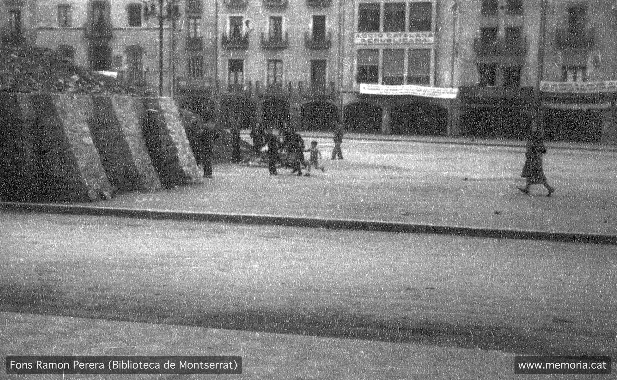 Vic. Octubre 1938. Plaça Major. Simulacre d’alarma de bombardeig al refugi número 3. Al fons es veuen les voltes de baix de la Plaça Major, amb pancartes. Hi ha el gran cartell de la seu d'Acció Catalana Republicana. (Cartera: 19 Foto: 494).
